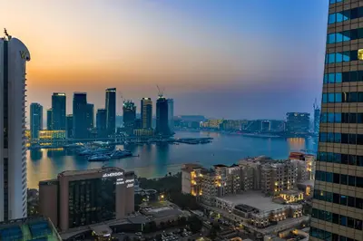 a view of a city with a river and buildings at Elegant 2BR - Stunning Sea Views & Prime Location in Dubai