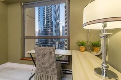 a room with a desk and a lamp and a window at Lux 4BHK in JBR 5 Mins Walk to Beach Sadaf 2 404 in Dubai