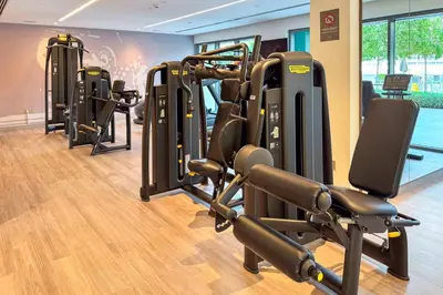 a gym with rows of exercise bikes and treadmills at PVH - Canal View 1BR - Burj Royale in Dubai