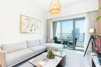 a living room with a couch and a large window at PVH - Canal View 1BR - Burj Royale in Dubai