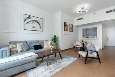 a living room with a couch and a table at White Sage Newly Renovated 1BR Business Bay Hamilton Residency in Dubai