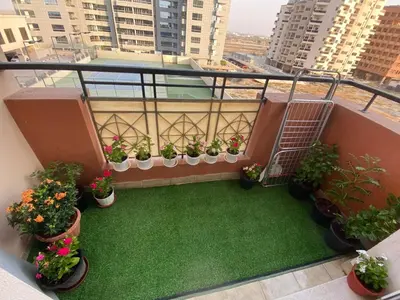 a balcony with potted plants on a building at Studio with homely cozy and positive vibes in Sabkhah