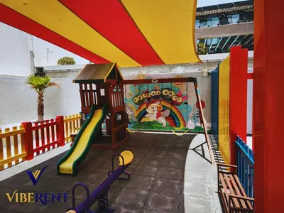 a playground with a slide in a building at Modern 1BR Apartment with Pool & Gym, 15 Min to JBR in Dubai