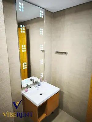 a bathroom with a sink and a mirror at Modern 1BR Apartment with Pool & Gym, 15 Min to JBR in Dubai