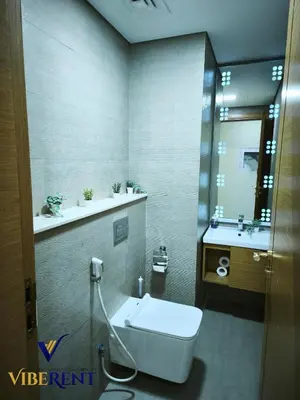 a bathroom with a toilet and a sink at Modern 1BR Apartment with Pool & Gym, 15 Min to JBR in Dubai