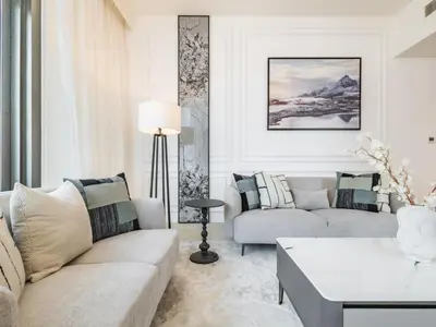 a living room with a couch and a table at The Norway Condo - 2BR Burj Khalifa View in Dubai