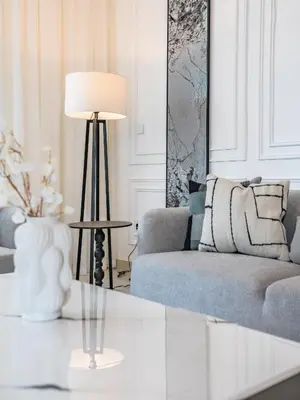 a living room with a couch and a table with a lamp at The Norway Condo - 2BR Burj Khalifa View in Dubai