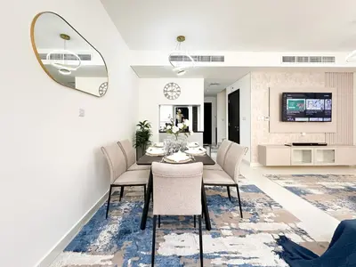 a dining room with a table and chairs at Stylish 3BR Retreat Bright Interiors Townhouse Comfort in Dubai