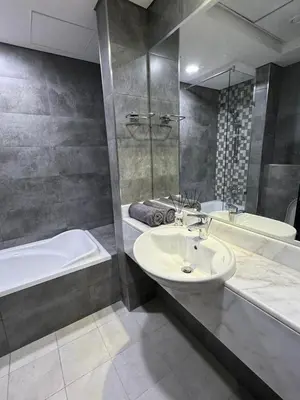 a bathroom with a sink and a bath tub and a tubermott at Luxury Private Capsule Room near Business Bay Downtown in Dubai