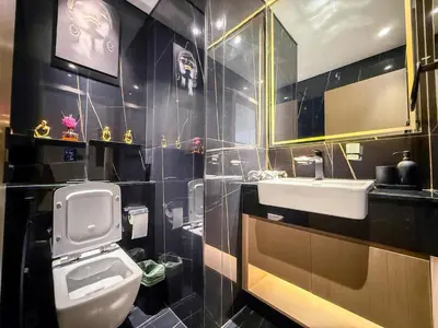 a bathroom with a white toilet and a sink at A Signature Living Experience Luxury One-Bedroom in Binghatti Emerald, JVC, Dubai in Dubai