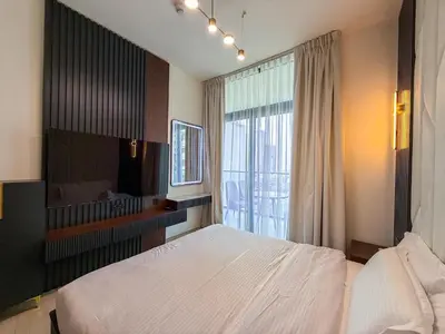 a bedroom with a large bed and a large window at A Signature Living Experience Luxury One-Bedroom in Binghatti Emerald, JVC, Dubai in Dubai