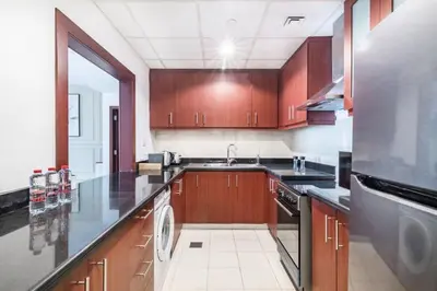 a large kitchen with a sink and a dishwasher at MiamiDXB Full Sea View -2Bd apartment in Dubai