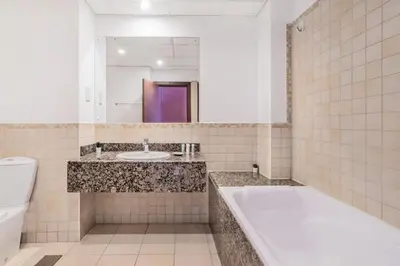 a bathroom with a tub and a sink and a toilet at MiamiDXB Full Sea View -2Bd apartment in Dubai