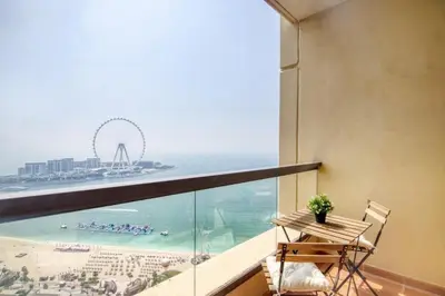 a balcony with a table and a view of the beach at MiamiDXB Full Sea View -2Bd apartment in Dubai