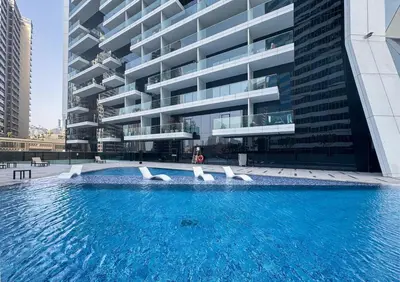 a large swimming pool in front of a building at Spacious Studio Private Balcony Sea View in Dubai