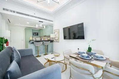 a living room with a couch and a table at EasyGo- Luxury Living with Resort Facilities and Amenities in Dubai