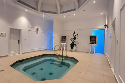 a large room with a swimming pool in the middle of the room at EasyGo- Luxury Living with Resort Facilities and Amenities in Dubai