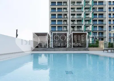 a swimming pool in front of a building at Bloomfields Cozy 1Br Binghatti House in Dubai