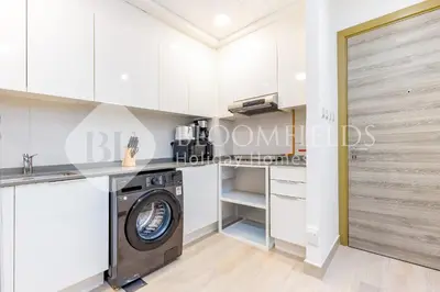 a laundry room with a washer and dryer at Bloomfields Spacious 1br Bloom Tower in Dubai