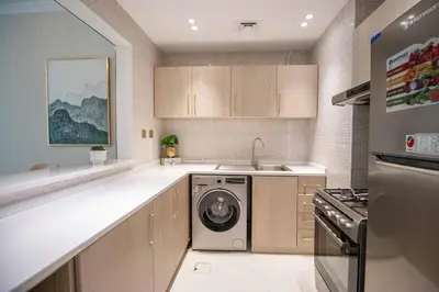 a kitchen with a washer and a sink and a dishwasher at Canal-View one bedroom Apt Business Bay in Dubai
