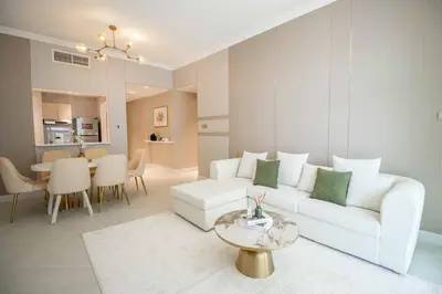 a living room with a white couch and a table at Canal-View one bedroom Apt Business Bay in Dubai