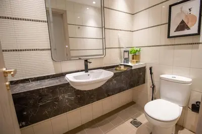 a bathroom with a white toilet and a sink at Canal-View one bedroom Apt Business Bay in Dubai