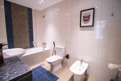 a bathroom with a toilet and a sink and a tub at Canal-View one bedroom Apt Business Bay in Dubai