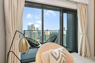 a room with a large window with a view of a city at Golden Stays - 5 Mins From Mall I Downtown Dream 1Br Apt in Dubai