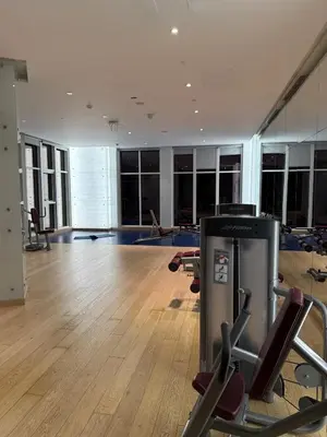 a gym with exercise equipment in a large room at Apartment In Downtown Dubai in Dubai
