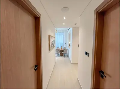 a hallway leading to a dining room with a table at Solysian Stay in Dubai