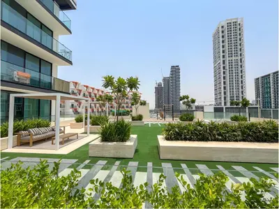 a courtyard in a building with benches and plants at Solysian Stay in Dubai