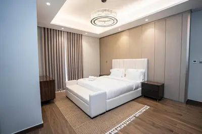 a bedroom with a large white bed in a room at Highlife Haven in Dubai with Pool and Gym in Dubai
