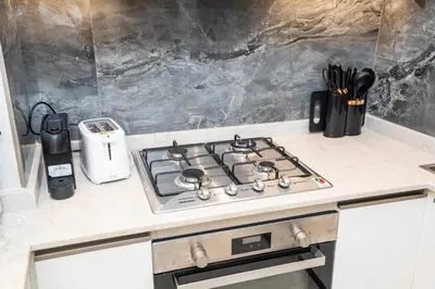 a stove top oven sitting on top of a kitchen counter at Highlife Haven in Dubai with Pool and Gym in Dubai