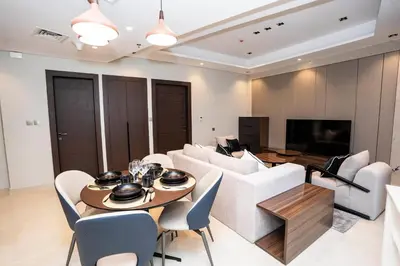 a living room with a couch and a table at Luxe 1BR Suite Dubai Dream Stay with Pool and Gym in Dubai