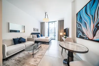 a living room with a couch and a table at Modern Studio I Smart Home I Business Bay in Dubai