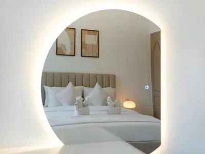 a bedroom with a white bed with an archway at Luxury 2BR- Pool with Burj View- 2 Min to Dubai Mall in Dubai