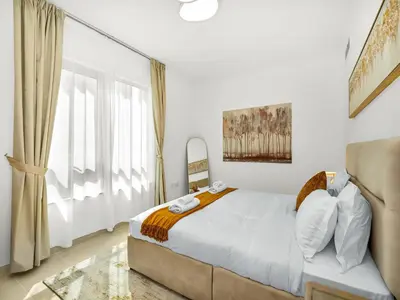 a bedroom with a bed and a large window at Luxury two Bedroom Apartment I Front row Downtown with Private Fountain & Burj View by Luxury Space in Dubai