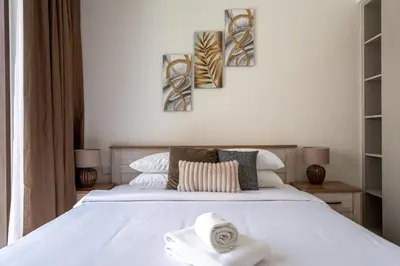 a bedroom with a bed with towels on it at GuestReady - Charming stay at Creek Beach in Dubai