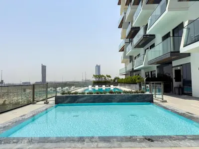 a swimming pool on the balcony of a building at Smart Home 1BR with Pool and City View in JVC by Bhavan Vacation Homes in Dubai