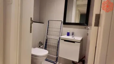 a bathroom with a toilet and a sink and a mirror at pearl 1bdr apartment in business bay in Dubai