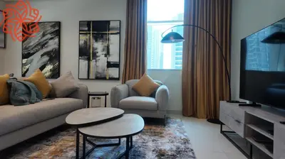 a living room with a couch and two chairs and a tv at pearl 1bdr apartment in business bay in Dubai