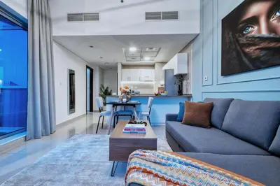 a living room with a couch and a table at Panoramic Marina Views Walk to Beach and JBR 1BR in Dubai