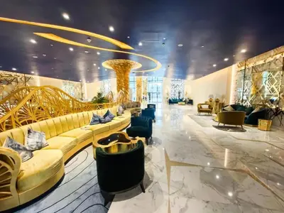 a lobby with couches and chairs in a building at Canal Bliss Balcony View in Dubai