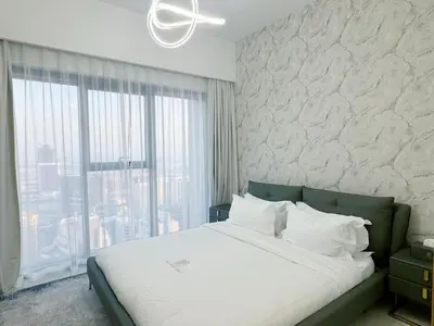 a bedroom with a large bed and a large window at Stylish & Comfy Downtown Oasis Views, Pool & Gym in Dubai