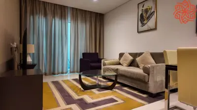 a living room with a couch and a glass table at Amazing 1bdr apartment in business bay in Dubai