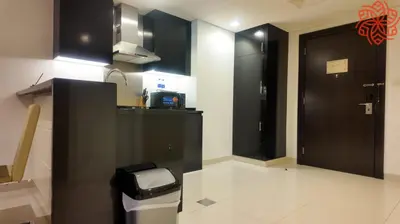 a kitchen with black cabinets and a trash can at Amazing 1bdr apartment in business bay in Dubai