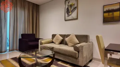 a living room with a couch and a glass table at Amazing 1bdr apartment in business bay in Dubai