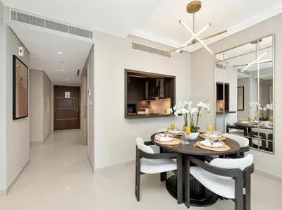 a dining room and kitchen with a table and chairs at Kensington 1BR and Study with Sofa Bed Burj View Dubal mall link in Dubai