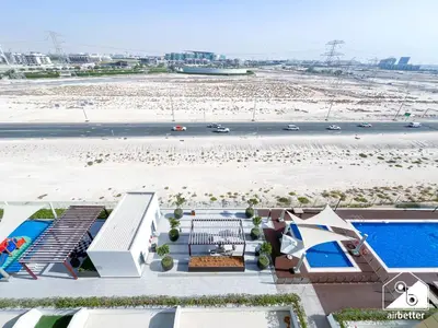 an aerial view of a resort with a pool at Serene Luxe l Modern 1BR in Meydan with Pool in Dubai