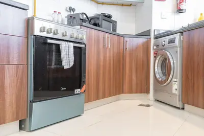a kitchen with a washer and a washing machine at Bright and Cozy 1BHK JVC by Czechin Great Location in Dubai